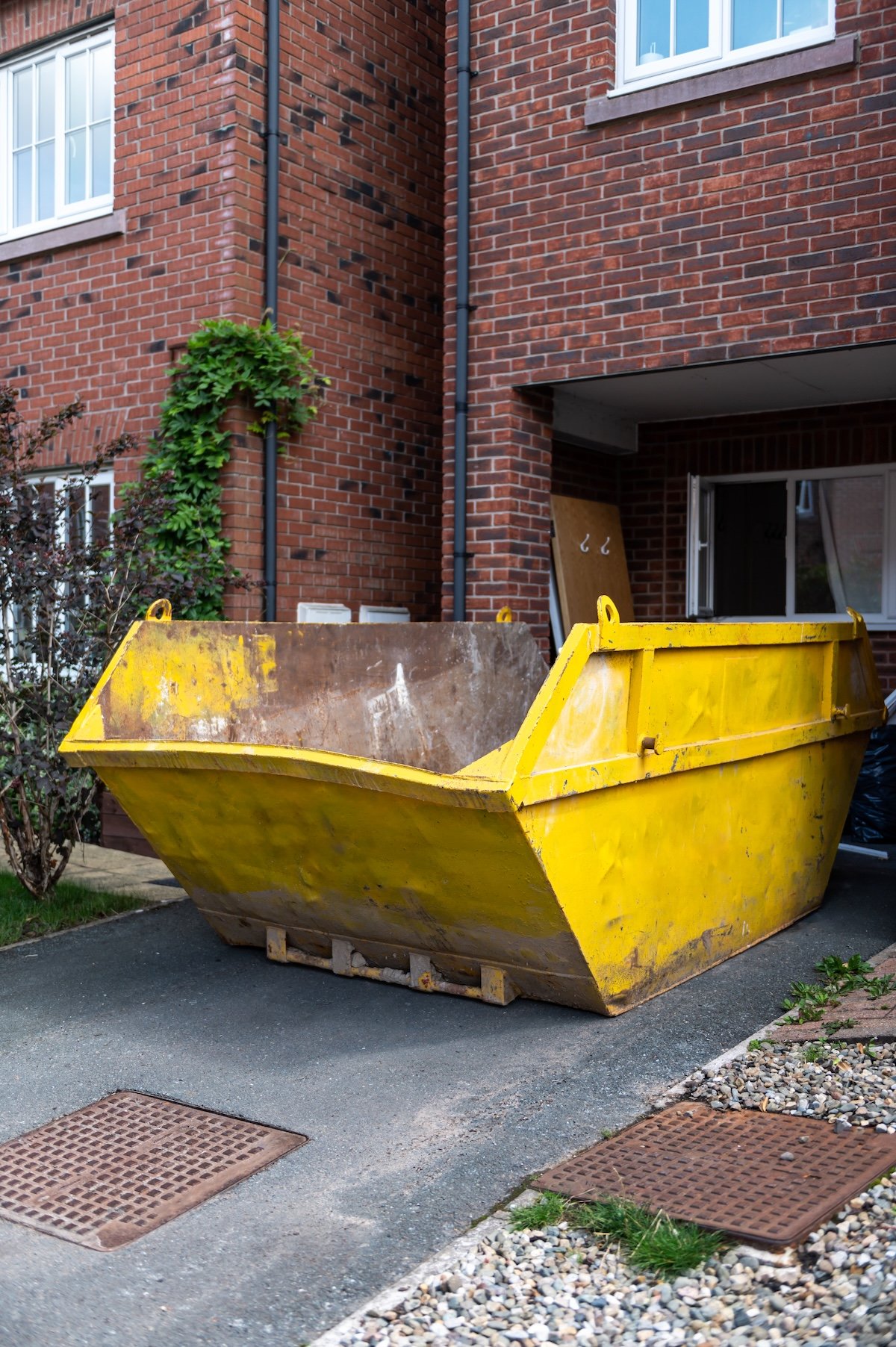 Large blue skip filled with building materials from a site clearance